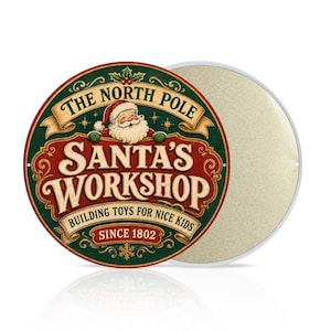 May include: A round metal sign featuring a graphic of Santa Claus and the text The North Pole Santa's Workshop Building Toys For Nice Kids Since 1802. The design uses a color palette of dark green, deep red, cream, and gold with decorative scrollwork.