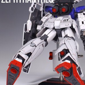 May include: A detailed model of a white and black robot with red and blue accents. The robot has intricate mechanical details, including visible joints, vents, and panels. The text "PROJECT 01 ZEPHYRANTHES" is visible in the upper left corner.