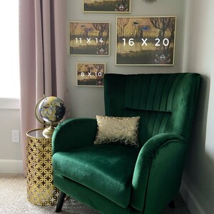 May include: A cozy living room scene featuring a deep green velvet armchair, a gold side table, and framed artwork. The artwork, in various sizes (8x10, 11x14, 12x16, and 16x20 inches), depicts a whimsical forest scene. A decorative gold pillow rests on the chair.
