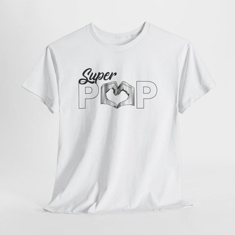 May include: White t-shirt with the text "Super Pop" in a black script font. The word "Pop" features a heart-shaped design in the center. The shirt is made of a soft material and has short sleeves.
