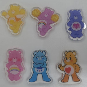 May include: A set of three ceramic nesting bowls in shades of blue, green, and white. The bowls feature a speckled glaze and a simple, modern design. The largest bowl measures approximately 6 inches in diameter.