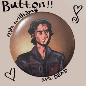 May include: A circular button with an illustration of a man with dark hair and a serious expression. The button has the text "Button!!" at the top, "ash williams" on the left, and "EVIL DEAD" at the bottom. The background is a gradient of brown and tan.
