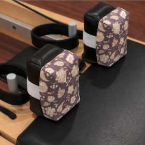 May include: A white ceramic mug with a black handle and the text "But First, Coffee" in a bold, black font. The mug is set against a neutral background, highlighting its simple design.