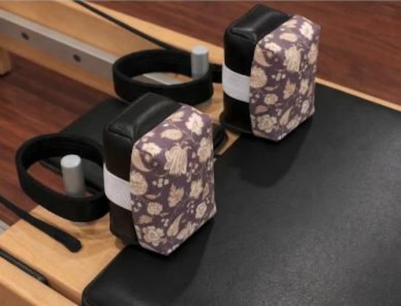 May include: A white ceramic mug with a black handle and the text "But First, Coffee" in a bold, black font. The mug is set against a neutral background, highlighting its simple design.