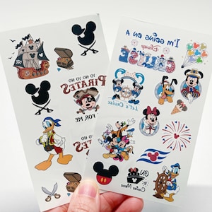 May include: Two sheets of temporary tattoos featuring Disney characters and nautical themes. Designs include a pirate ship, treasure chests, Mickey Mouse icons, Donald Duck, Pluto, and text such as "I'm going on a cruise" and "Yo ho ho pirates for me."