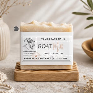 May include: A rectangular bar of goat milk soap with a textured, off-white surface. The label features a goat illustration, the text "YOUR BRAND NAME", "GOAT MILK", "AUSTIN TEXAS", "TABACCO + BAY LEAF", "NATURAL & HANDMADE", and "NET 4oz | 120g".