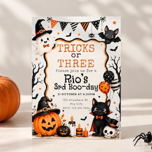 May include: A rectangular Halloween-themed birthday invitation card featuring a white ghost, a black cat, a jack-o'-lantern, and bats. The text reads: TRICKS OR THREE, Please join us for a Rio's 3rd Boo-day, 31 OCTOBER AT 6:00PM, 123 Anywhere St., Any City, RSVP: 123-456-7890.