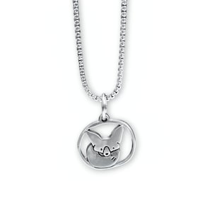 May include: A silver necklace with a pendant featuring a stylized fox curled up inside a circle.