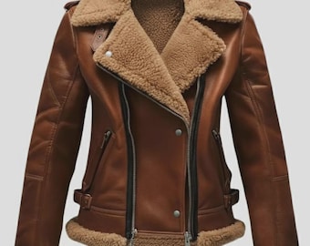 May include: Brown leather jacket with a shearling collar and lining. The jacket features a classic asymmetrical zipper closure, multiple pockets, and a belt at the waist. The cuffs are also lined with shearling. A stylish outerwear piece.