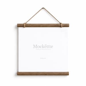 May include: A square wall hanging frame featuring two dark brown wooden bars at the top and bottom, connected by a thin jute rope for suspension. The center displays a white rectangular surface with the text Mockette Premium Mockup Store.