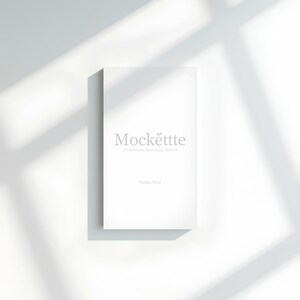 May include: A white rectangular product mockup with the text "Mockëttte Premium Mockup Store" in gray. The image is set against a white background with shadows.