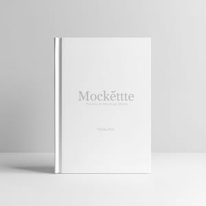 May include: A white book with the text "Mockëttte Premium Mockup Store" and "PSD & JPEG" printed on the cover. The book is standing upright on a white surface.