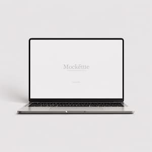 May include: A silver laptop with a black keyboard and a blank white screen. The screen displays the text Mockette Premium Mockup Store in the center. The device is shown from a front-facing perspective, featuring a thin bezel and a metallic finish.