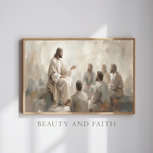 Puede incluir: Una impresión enmarcada que representa una escena religiosa. La obra presenta una figura central con túnicas blancas, gesticulando hacia un grupo de individuos sentados. La paleta de colores es suave, con tonos apagados de beige y gris. El texto "BEAUTY AND FAITH" está en la parte inferior.