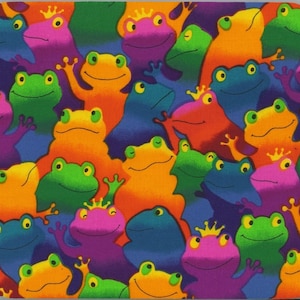May include: A colorful mousepad featuring a repeating pattern of frogs wearing crowns. The frogs are in various shades of blue, green, orange, pink, and purple.