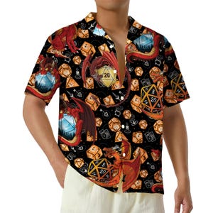 May include: Black button-down shirt with a repeating pattern of orange dice, red dragons, and blue landscape dice. The shirt features short sleeves and a classic collar. The design is detailed and vibrant, perfect for fans of fantasy games.
