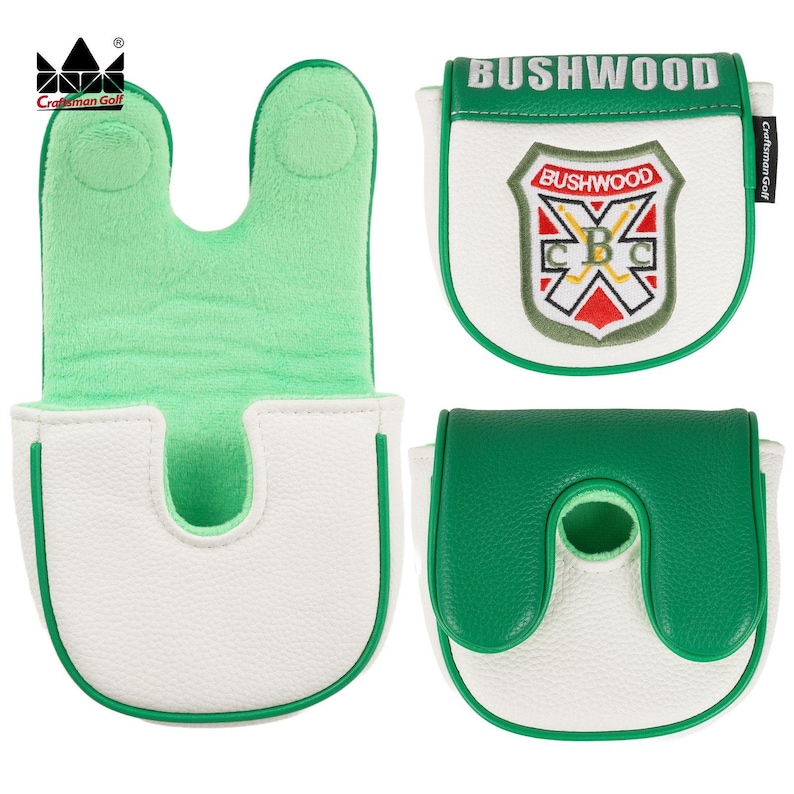 K&ouml;nnte beinhalten: Wei&szlig;e und gr&uuml;ne Golf-Putter-Schl&auml;gerhauben. Eine Haube hat eine gr&uuml;ne Innenseite und ein U-f&ouml;rmiges Design. Eine weitere Haube zeigt den Text "BUSHWOOD" und ein Schilddesign. Die Hauben werden von Craftsman Golf hergestellt.