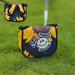 May include: A golf club head cover with a sunflower design. The cover is primarily navy blue with yellow sunflower petals and a black trim. The cover has the text "PGM4G" and a smiling face logo.
