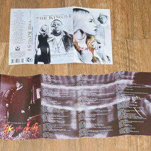 May include: Folded CD insert with album art. The top insert features images of a woman, a man, and the text "THE KING & I". The bottom insert is open, displaying images and lyrics. The album title "THE NOTORIOUS B.I.G. LIFE AFTER DEATH" is visible.