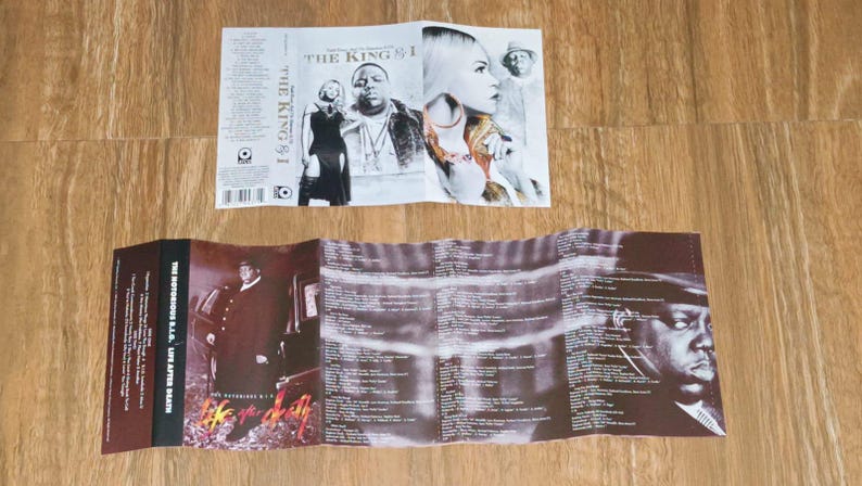 May include: Folded CD insert with album art. The top insert features images of a woman, a man, and the text "THE KING & I". The bottom insert is open, displaying images and lyrics. The album title "THE NOTORIOUS B.I.G. LIFE AFTER DEATH" is visible.