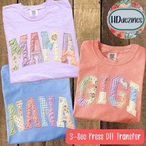 May include: Three Comfort Colors t-shirts in lavender, peach, and blue. Each shirt features a patchwork design spelling "MAMA", "GIGI", and "NANA" in a collegiate font. The text "3-Sec Press DTF Transfer" is at the bottom.