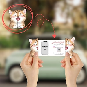 May include: A business card featuring a smiling cartoon kitten with brown and tan fur. The card has a smartphone graphic with the text "INSTAGRAM PROFILE HERE" and the text "Snowball Shop" with an Instagram handle. The background is blurred.