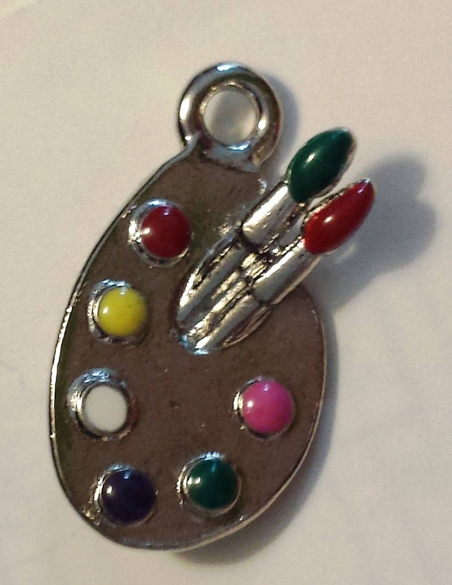 silver tone charm with enamel paint color -breast cancer, artist, ballet