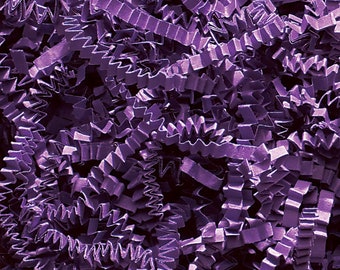 May include: Close-up of purple crinkle paper, a decorative packaging material. The paper is cut into long, zig-zag strips, creating a textured and visually interesting effect. The color is a deep, saturated purple, suitable for gift wrapping or basket filler.