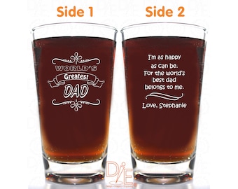 May include: Two clear glass pint glasses with a brown liquid inside. The glass on the left has the text "WORLD'S Greatest DAD" engraved on it. The glass on the right has the text "I'm as happy as can be. For the world's best dad belongs to me. Love, Stephanie" engraved on it.