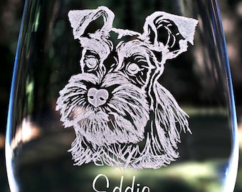 May include: A clear glass wine glass with an etched image of a miniature schnauzer dog. The dog's name, "Eddie", is etched below the image.