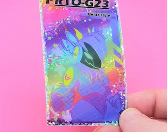 May include: A holographic sticker featuring a stylized purple character with a black visor and yellow accents. The sticker has the text "PRTO-G23" and "Beats style" in a colorful design with glitter accents.