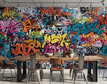 May include: A dining room featuring a large wooden table with metal legs and six chairs. The focal point is a vibrant graffiti mural in shades of orange, yellow, pink, and blue. A modern industrial style.