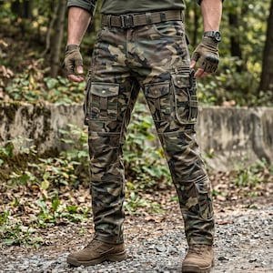 May include: Camouflage cargo trousers featuring multiple utility pockets with buttoned flaps, a reinforced waistband with belt loops, and a tactical belt. The trousers display a multi-tone green, brown, and black pattern, paired with brown boots.