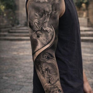 May include: Black and white tattoo of two lions on an arm. The top lion is nuzzling the other. The word "loyalty" is written in cursive on the forearm. The tattoo is detailed and realistic.