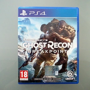 May include: A PS4 game case for Tom Clancy's Ghost Recon Breakpoint. The cover art features two soldiers in combat gear, one carrying the other. The game's title is prominently displayed, with the Ubisoft logo at the bottom.