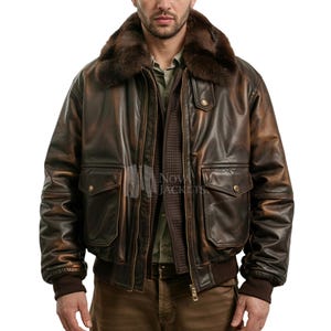 May include: A dark brown leather bomber jacket featuring a plush fur collar, a front zipper closure, and two large flap pockets with snap buttons. The jacket has ribbed cuffs and a hem, with the text Nova Jackets visible on the inner placket.