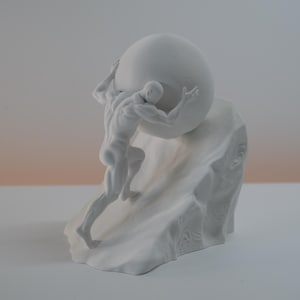 May include: A matte white sculpture depicting a muscular figure pushing a large sphere up a rocky incline. The figure is shown in a dynamic pose with defined musculature, leaning into the weight of the round object while ascending the textured base.