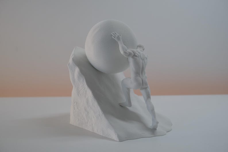 May include: A matte white sculpture depicting a muscular figure pushing a large sphere up a steep, textured incline. The figure is shown from behind, with arms extended upward against the round object, set against a plain, neutral background.