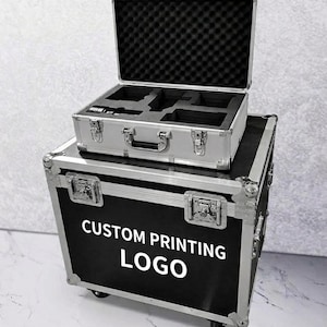 May include: Two-piece set of aluminum cases. The top case is open, revealing a black foam interior with cutouts. The bottom case is black with silver trim and the text "CUSTOM PRINTING LOGO" in white.
