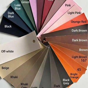 May include: A color palette fan featuring a variety of hues, including shades of blue, green, purple, red, pink, orange, brown, and gray. Each color is labeled with its name, such as "Dark Blue," "Wine Red," and "Bright Orange." The fan includes a range of materials.