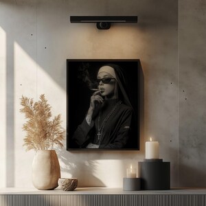 High-contrast digital print of a nun for meditation area — moody, provocative wall art showcasing tattoos and a distinctive noir vibe.
