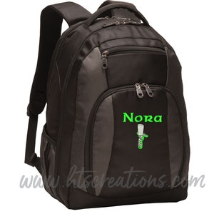 May include: Black and grey backpack with a green embroidered design of a Celtic knot and the name "Nora".