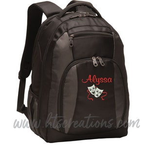 May include: Black and gray backpack with a zippered pocket and a large compartment. The backpack has a red embroidered name "Alyssa" and two white theater masks.