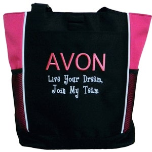 May include: Black tote bag with pink accents and white trim. The bag has a mesh pocket on each side. The front of the bag has pink embroidered text that reads "AVON Live Your Dream, Join My Team."