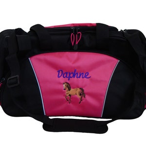 May include: Pink and black duffel bag with a horse and the name Daphne embroidered on the front.