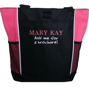 May include: Black tote bag with pink accents and a white embroidered logo that says "MARY KAY Ask me for a brochure!"