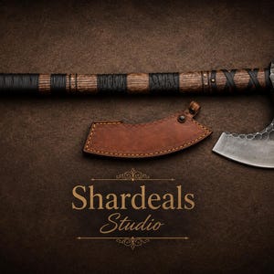 May include: A hand axe with a dark, hammered metal head and a long wooden handle wrapped in black leather cord. A brown leather sheath with visible stitching sits below the axe head. The text Shardeals Studio is printed in gold below.