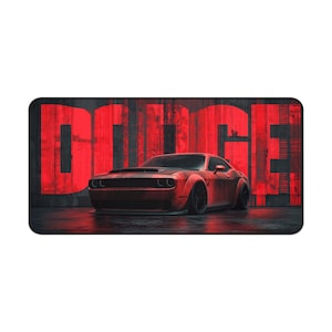 May include: A red Dodge muscle car is parked in front of a red and black wall with the word "DODGE" in large letters. The car has black wheels and is on a wet surface.