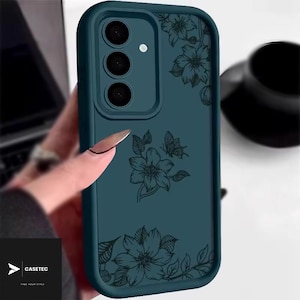 May include: Teal phone case with a floral design. The case features a dark teal color with a black floral pattern and a butterfly. The case has a camera cutout and the brand name "CASETEC".