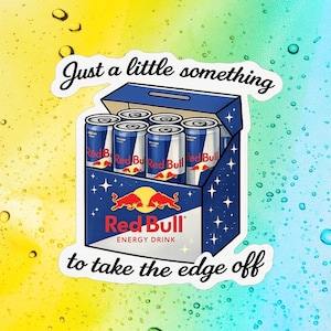 May include: A sticker depicting a six-pack of Red Bull energy drink cans in a blue box. The Red Bull logo is visible, with the text "Just a little something to take the edge off."